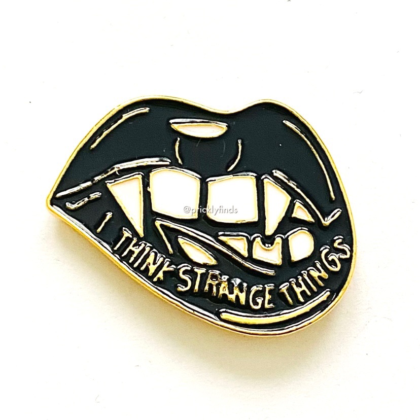 8/$40 I Think Strange Things Biting Lips Enamel Pin